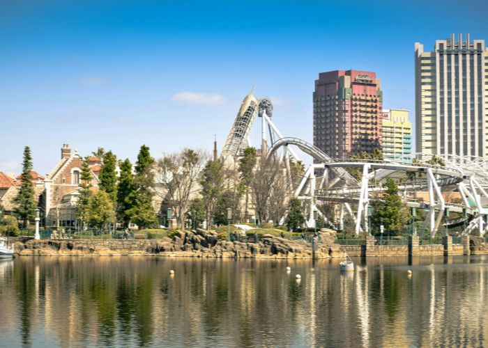 A shot of Universal Studios Japan on a sunny day, showing multiple rollercoasters and buildings in the background.